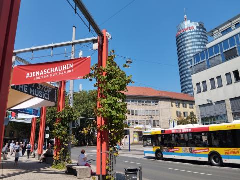 Banner am Holzmarkt mit dem Signet der Kampagne #JenaSchauHin